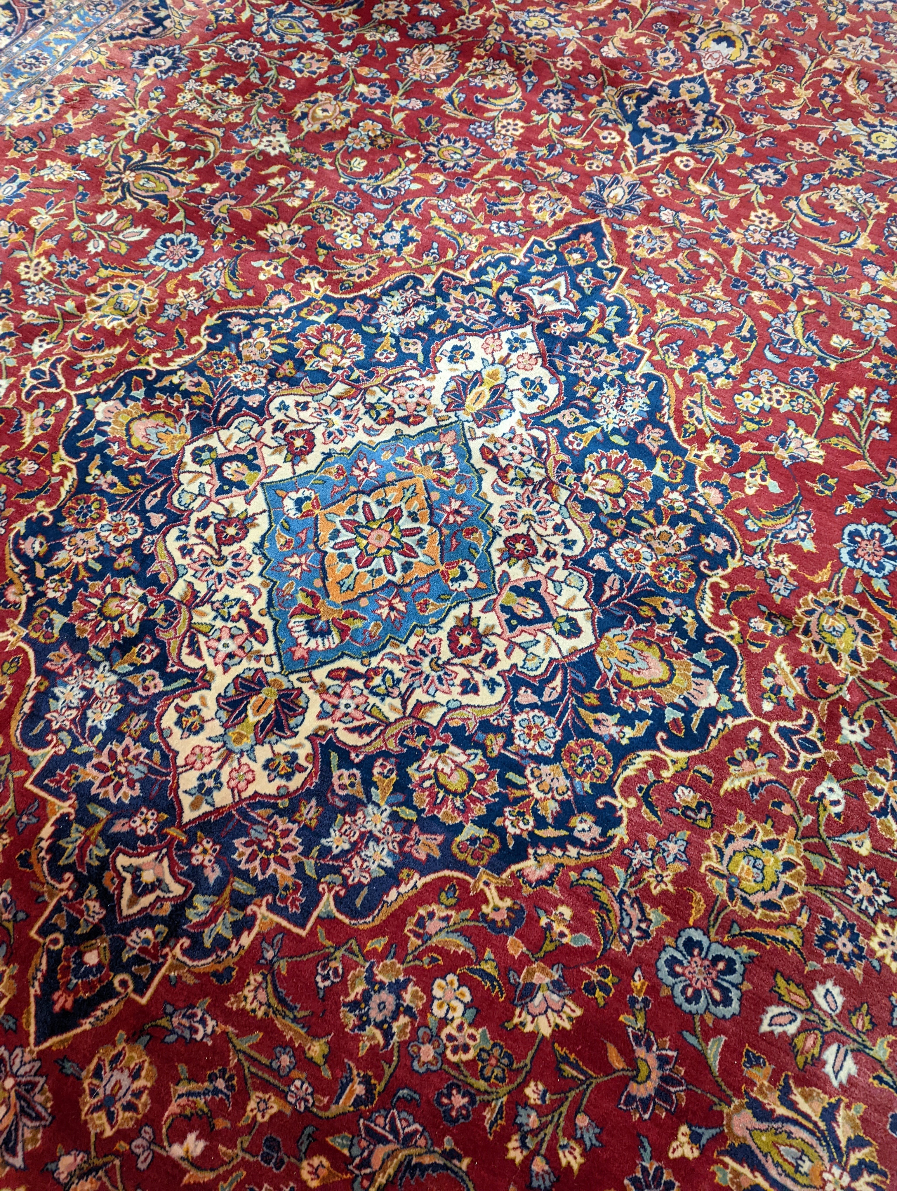 A large Tabriz red ground floral carpet, 540 x 350cm